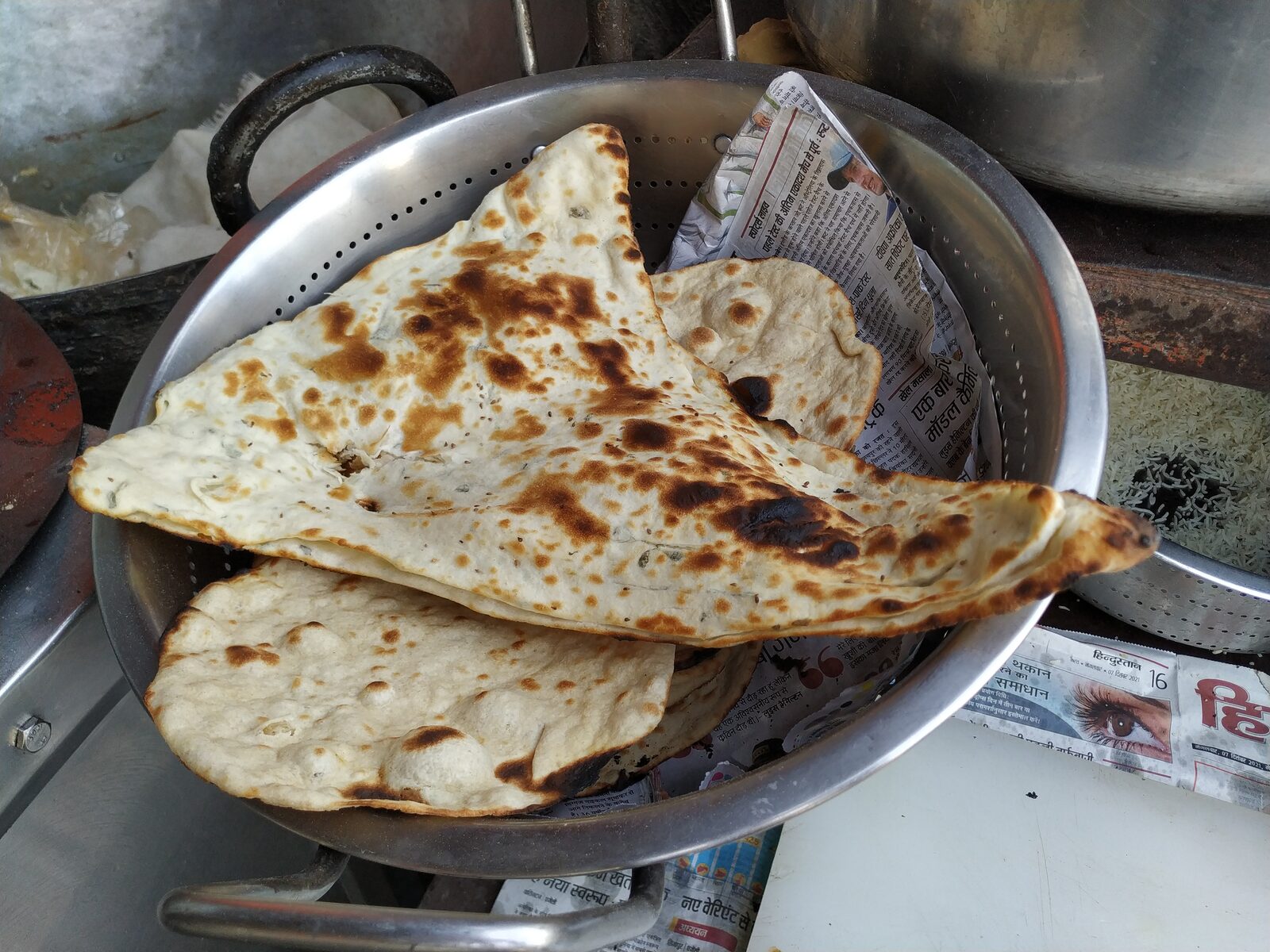 Fresh naan bread baked in a tandoor oven