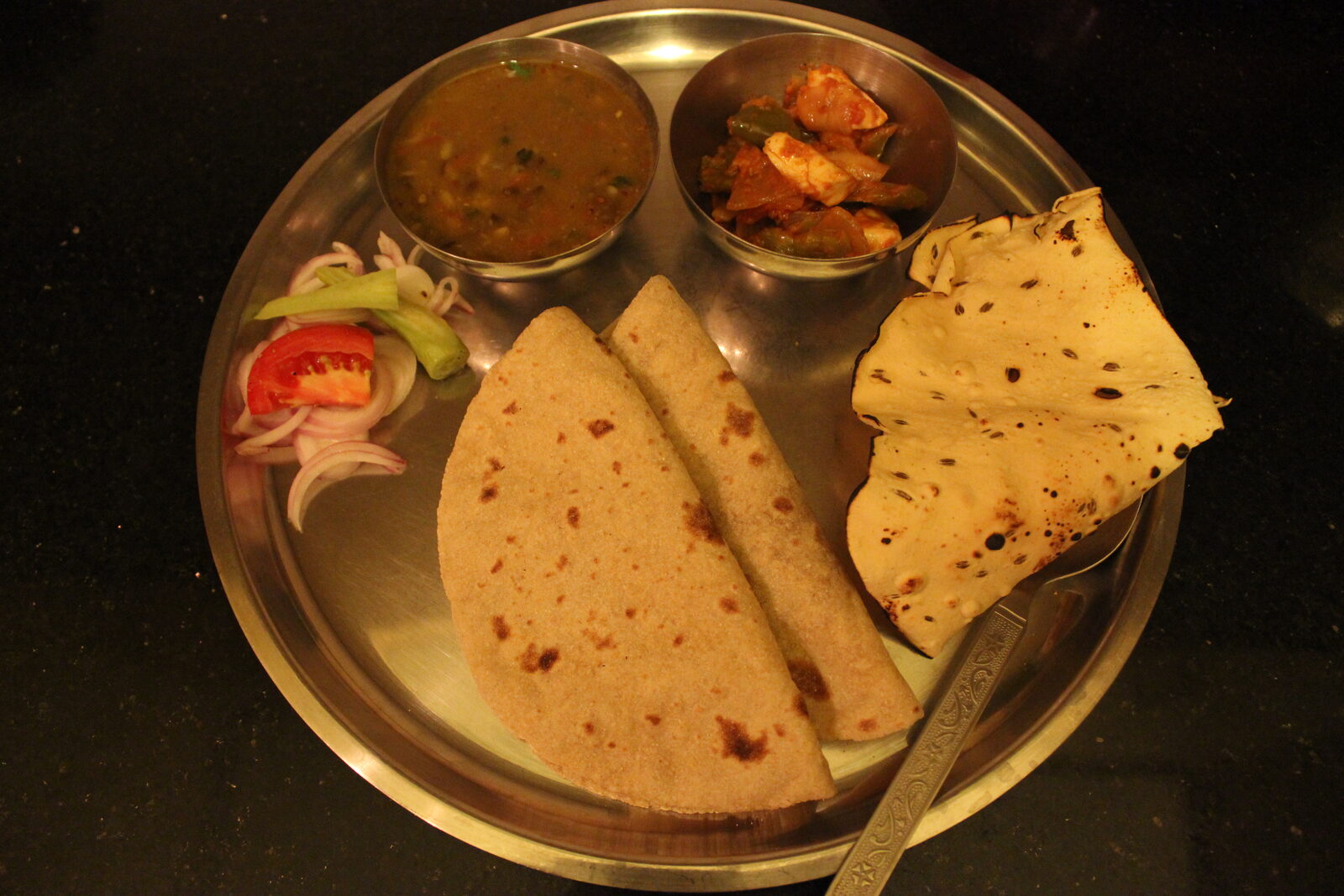Punjabi thali with paneer curry, dal makhani, jeera rice and butter naan