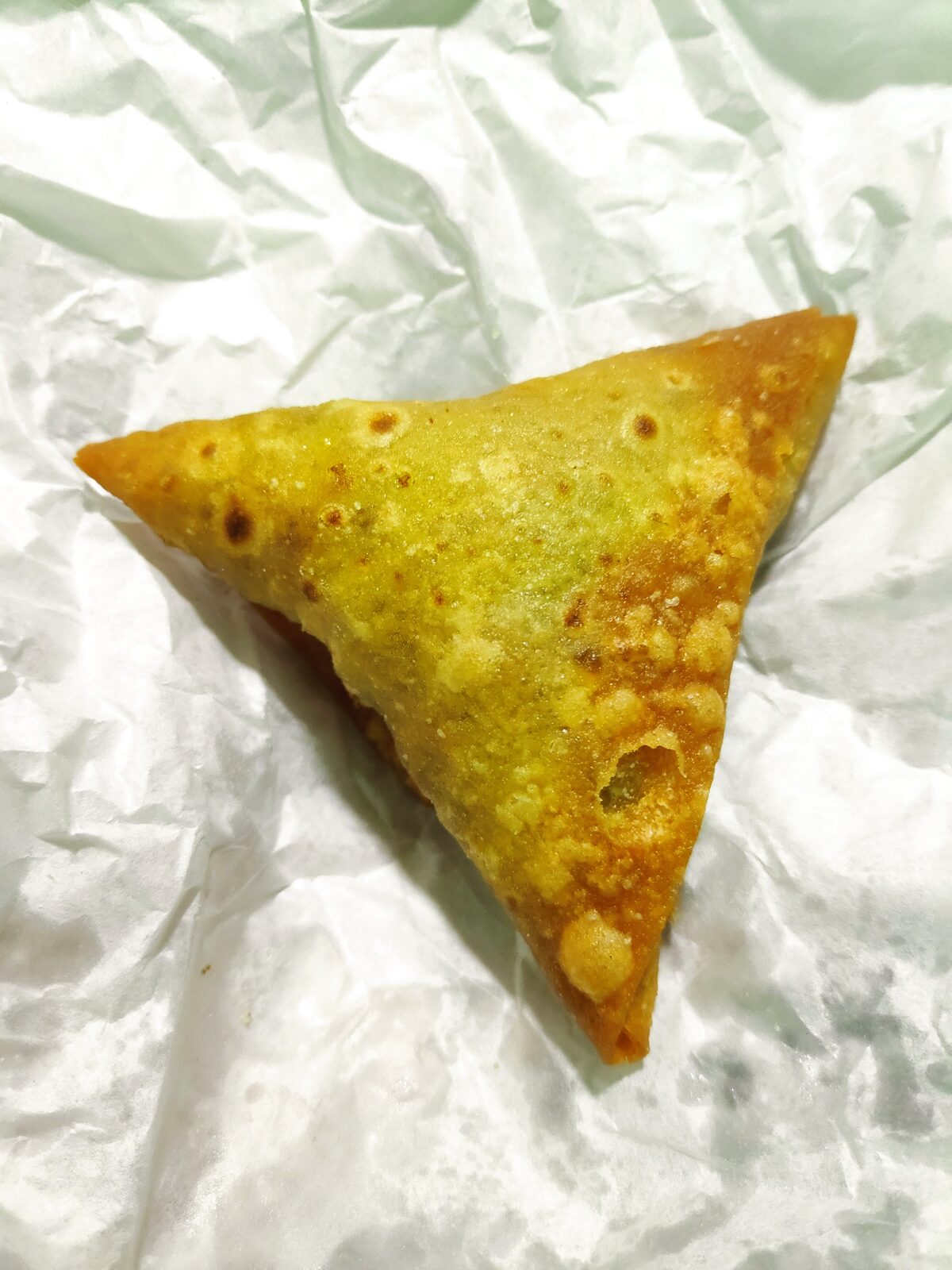 Crispy golden vegetable samosas served with chutneys