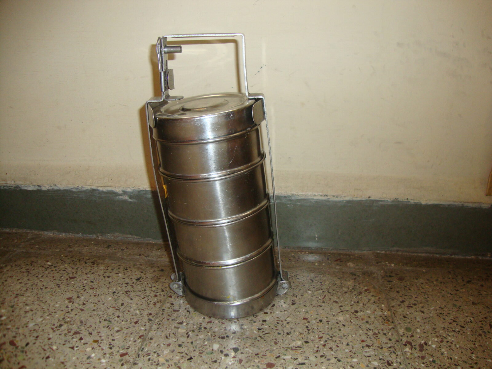 A traditional stainless steel tiffin carrier packed with home-style Indian meal, the Bhakti Foods tiffin service concept