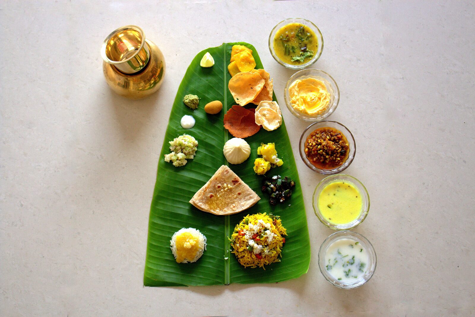 A generous Bhakti Foods vegetarian thali with dal, sabzi, rice, roti and accompaniments, served on a steel plate